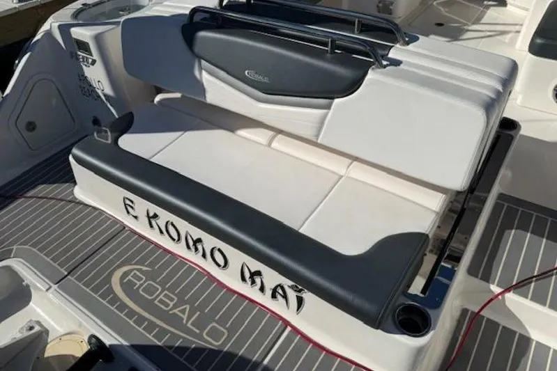 E Komo Mai Yacht Photos Pics 2021 Robalo R317 Dual Console boat seating area with "E Komo Mai" text.