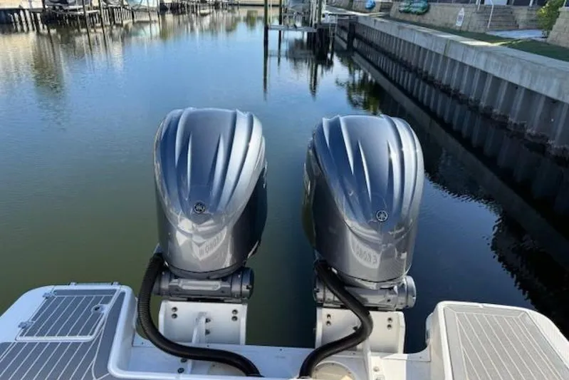 E Komo Mai Yacht Photos Pics 2021 Robalo R317 Dual Console with twin outboard engines on calm water.