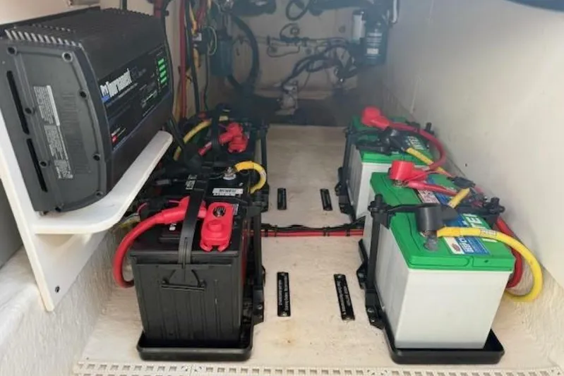 E Komo Mai Yacht Photos Pics 2021 Robalo R317 Dual Console boat battery compartment with multiple batteries and wiring.