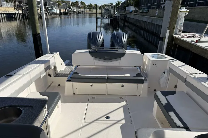 E Komo Mai Yacht Photos Pics 2021 Robalo R317 Dual Console boat interior with seating and water view.