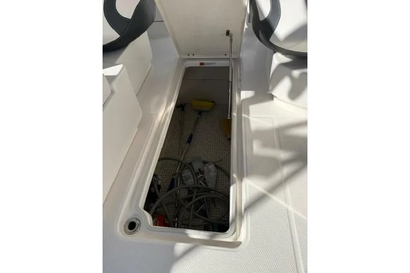 E Komo Mai Yacht Photos Pics 2021 Robalo R317 Dual Console storage compartment with equipment and tools inside.