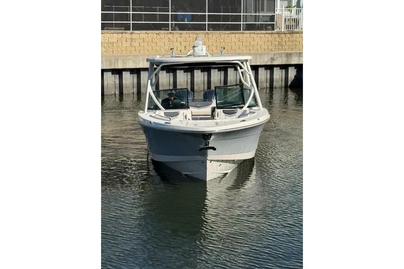 E Komo Mai Yacht Photos Pics 2021 Robalo R317 Dual Console boat docked in calm waters.