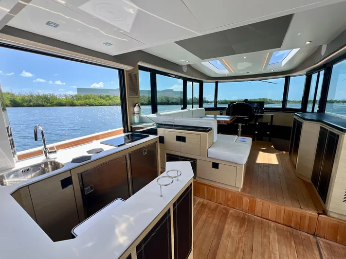  Yacht Photos Pics Luxurious interior of 2022 OKEAN Flybridge 50 yacht with panoramic windows and modern kitchen.