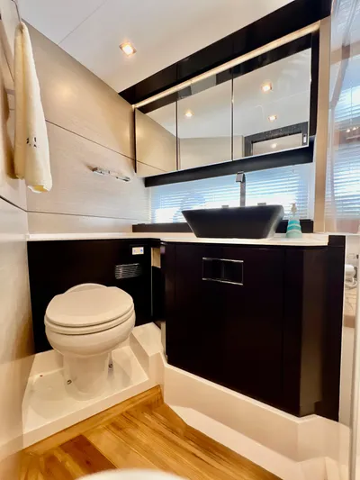 Yacht Photos Pics Modern bathroom on 2022 OKEAN Flybridge 50 yacht with sleek fixtures and wooden flooring.