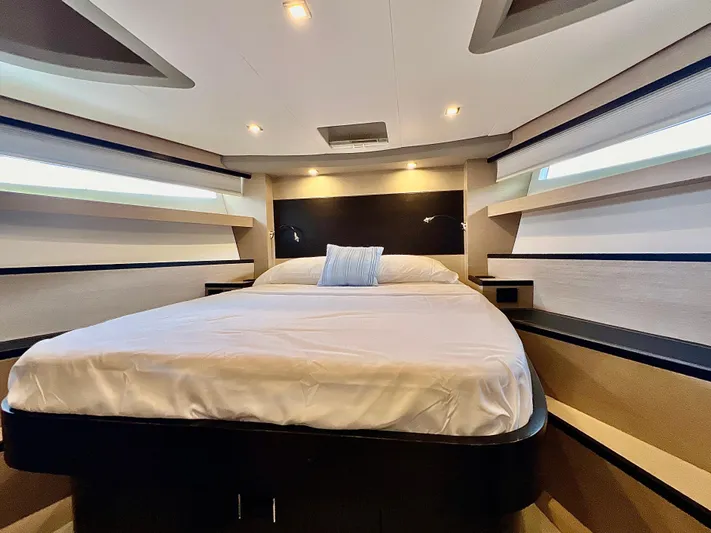  Yacht Photos Pics Luxurious bedroom interior of 2022 OKEAN Flybridge 50 yacht with modern lighting.