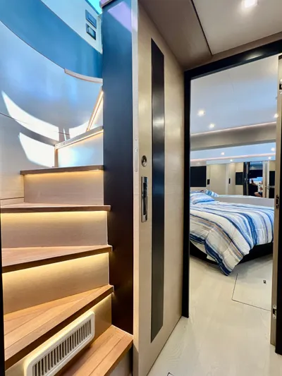  Yacht Photos Pics Modern interior of 2022 OKEAN Flybridge 50 yacht with wooden stairs and cozy bedroom.