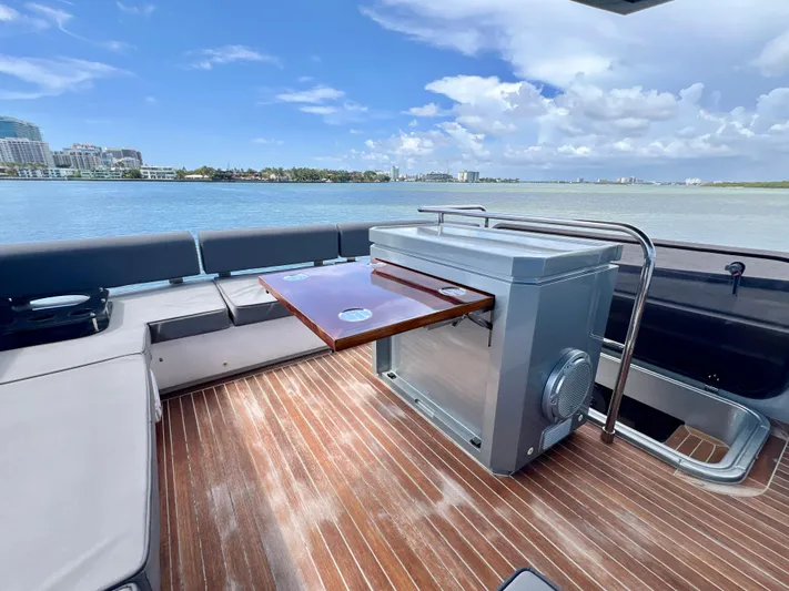  Yacht Photos Pics 2022 OKEAN Flybridge 50 yacht deck with seating and table, overlooking serene waters.