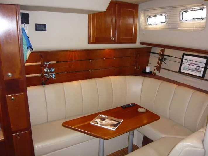 Bobalu Yacht Photos Pics Luxurious interior of 2004 Rampage 38 Express yacht with leather seating and wooden accents.