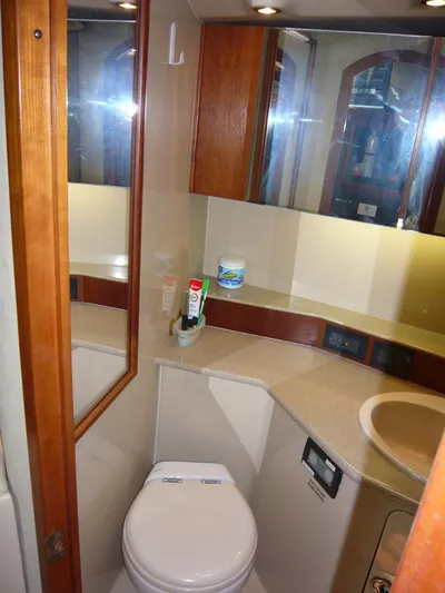 Bobalu Yacht Photos Pics 2004 Rampage 38 Express yacht bathroom with mirror, sink, and toilet.