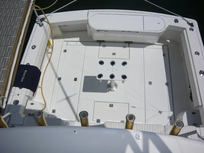 Bobalu Yacht Photos Pics 2004 Rampage 38 Express boat deck with fishing rod holders and storage compartments.