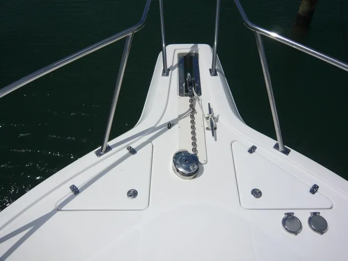 Bobalu Yacht Photos Pics Bow of 2004 Rampage 38 Express boat with anchor chain and railing.
