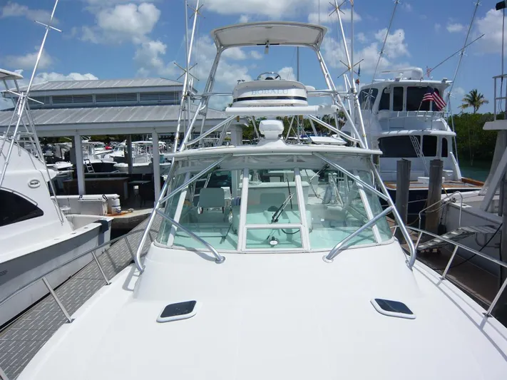 Bobalu Yacht Photos Pics 2004 Rampage 38 Express boat docked at marina under clear blue sky.