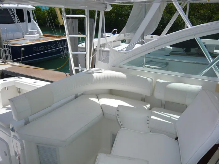 Bobalu Yacht Photos Pics 2004 Rampage 38 Express yacht with white seating in a marina setting.