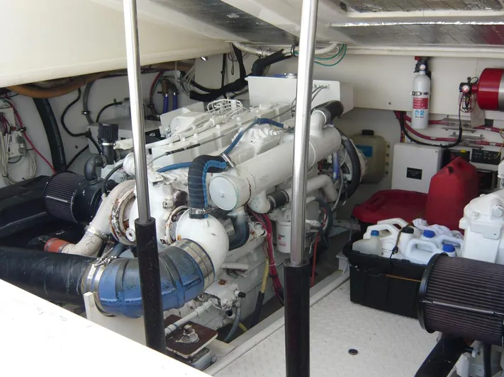 Bobalu Yacht Photos Pics Engine room of a 2004 Rampage 38 Express boat, featuring mechanical components and storage items.