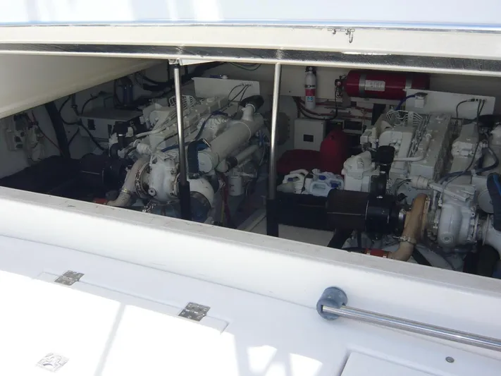 Bobalu Yacht Photos Pics Engine room of a 2004 Rampage 38 Express boat, showcasing dual engines and equipment.