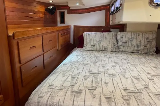 Alegria Yacht Photos Pics Cozy 2007 Tartan 4400 yacht cabin with wooden interior and nautical-themed bedding.