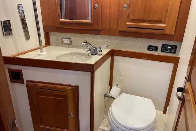 Alegria Yacht Photos Pics Compact bathroom in 2007 Tartan 4400 yacht with wooden cabinetry and modern fixtures.