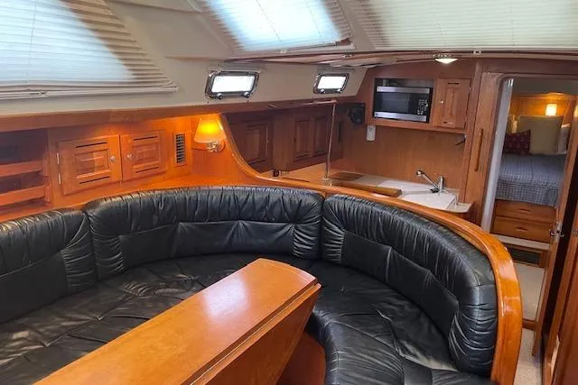 Alegria Yacht Photos Pics Luxurious interior of 2007 Tartan 4400 yacht with leather seating and wooden finishes.