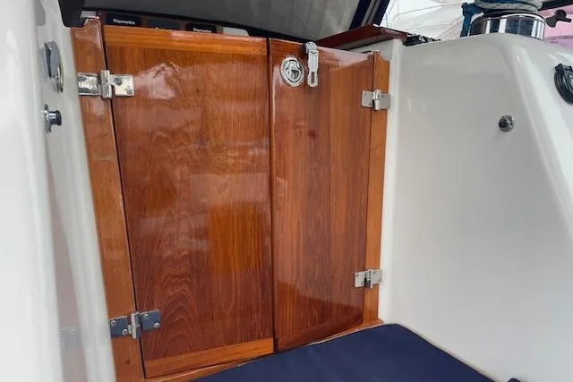 Alegria Yacht Photos Pics Wooden cabin doors on a 2007 Tartan 4400 yacht, featuring polished hinges and latch.
