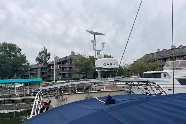 Alegria Yacht Photos Pics Tartan 4400 sailboat, 2007 model, docked with Garmin equipment, overcast sky, waterfront buildings.