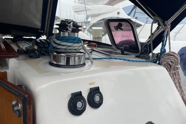 Alegria Yacht Photos Pics 2007 Tartan 4400 sailboat deck with winch and ropes in marina setting.