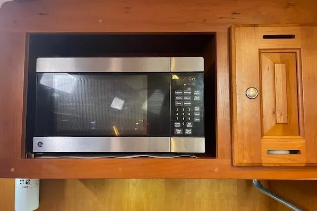 Alegria Yacht Photos Pics Built-in microwave in wooden cabinet, Tartan 4400, 2007 model.
