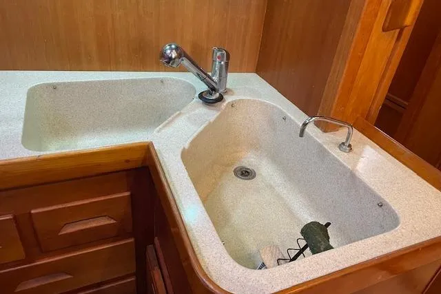 Alegria Yacht Photos Pics Double sink in a 2007 Tartan 4400 yacht kitchen with wooden cabinetry.