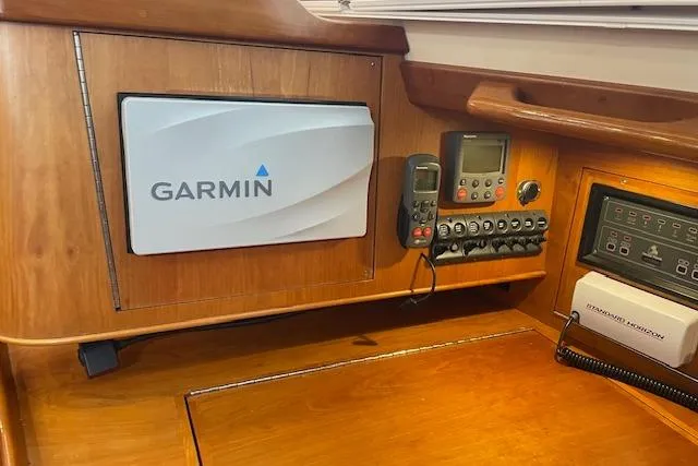 Alegria Yacht Photos Pics Navigation equipment on a 2007 Tartan 4400 yacht, featuring Garmin and control panels.