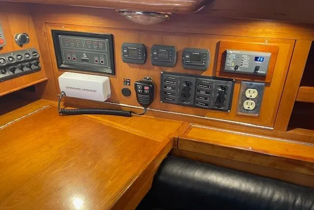 Alegria Yacht Photos Pics Control panel of a 2007 Tartan 4400 yacht with various switches and outlets.