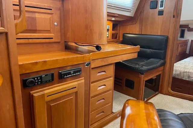 Alegria Yacht Photos Pics Luxurious 2007 Tartan 4400 yacht interior with wooden cabinetry and seating area.