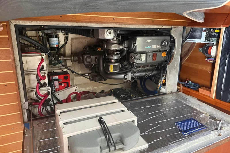 Alegria Yacht Photos Pics Engine compartment of a 2007 Tartan 4400 sailboat, showcasing mechanical components and wiring.