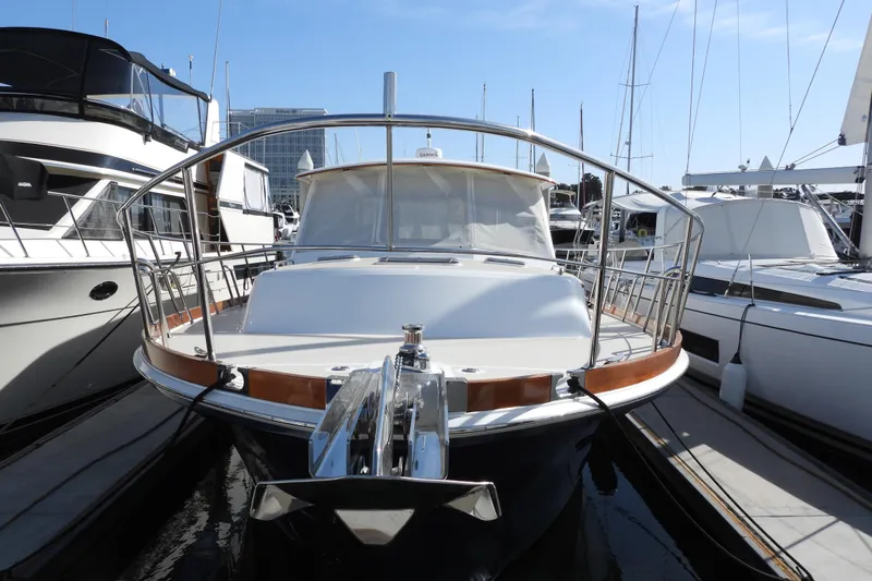  Yacht Photos Pics 2015 Grand Banks 46 Eastbay SX yacht docked at marina, front view.