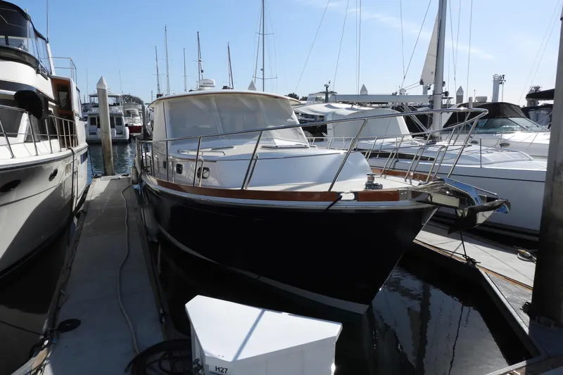  Yacht Photos Pics 2015 Grand Banks 46 Eastbay SX yacht docked at marina, surrounded by other boats.