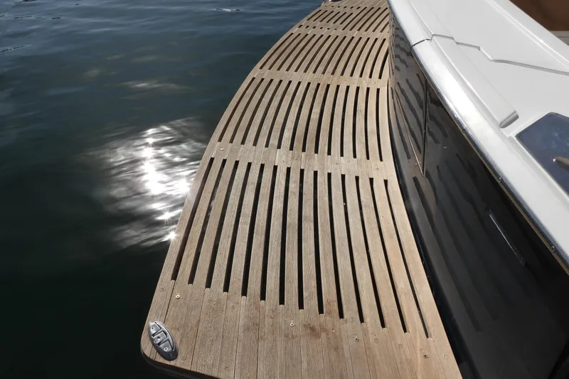  Yacht Photos Pics Teak deck of 2015 Grand Banks 46 Eastbay SX yacht reflecting sunlight on water.