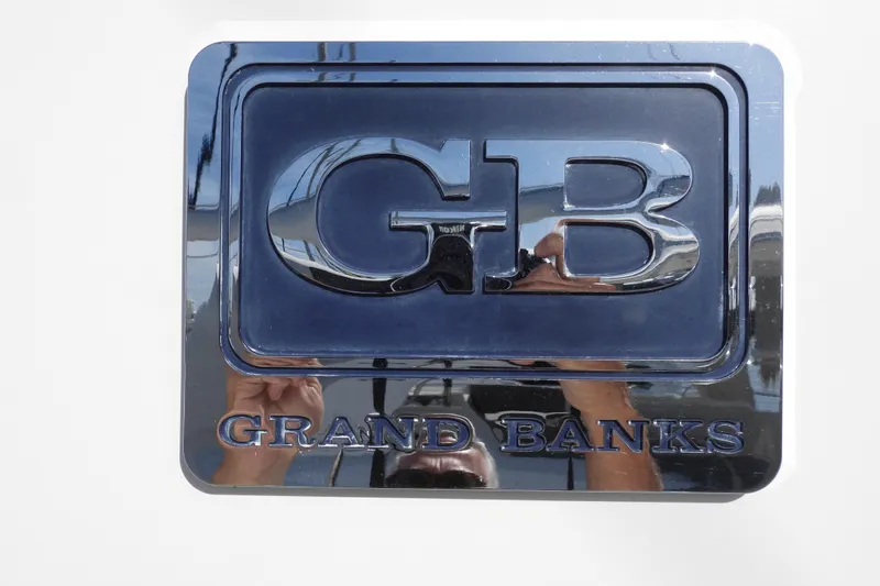  Yacht Photos Pics Chrome emblem of 2015 Grand Banks 46 Eastbay SX yacht, featuring "GB" logo.