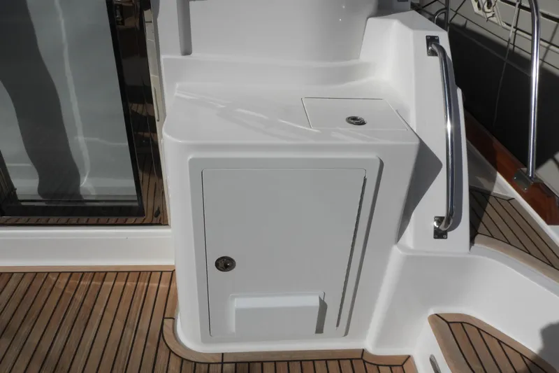  Yacht Photos Pics 2015 Grand Banks 46 Eastbay SX yacht deck with storage compartment and railing.