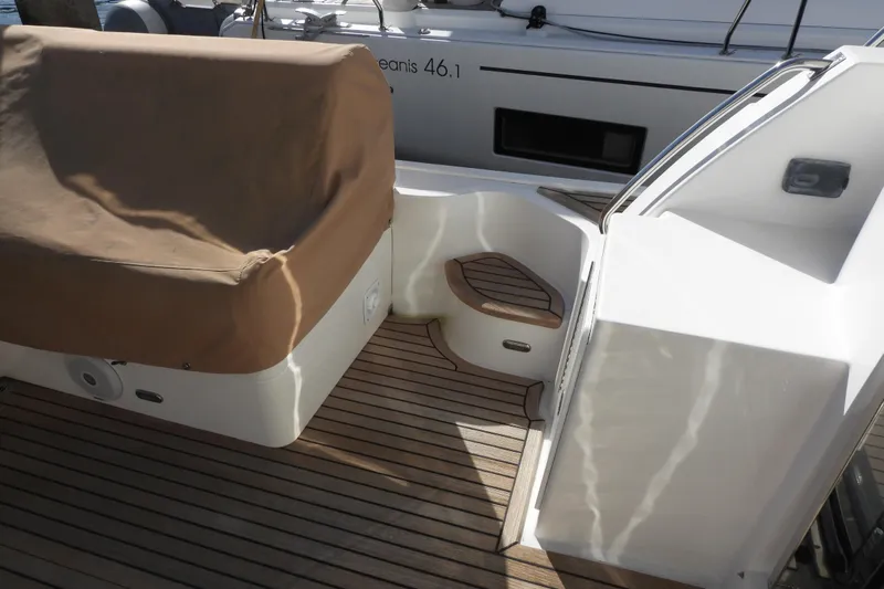  Yacht Photos Pics 2015 Grand Banks 46 Eastbay SX yacht deck with covered seating and wooden flooring.