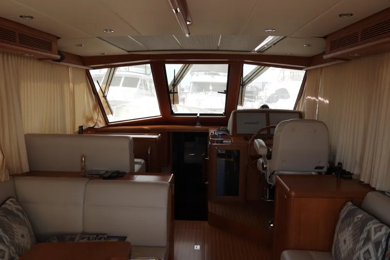  Yacht Photos Pics Interior of 2015 Grand Banks 46 Eastbay SX yacht, featuring helm and seating area.