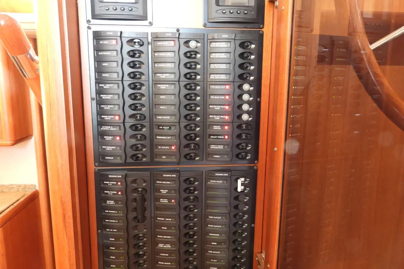  Yacht Photos Pics Electrical control panel on 2015 Grand Banks 46 Eastbay SX yacht, featuring labeled switches and indicators.