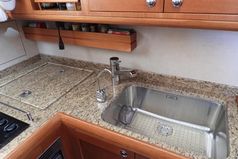  Yacht Photos Pics Luxurious kitchen sink area on 2015 Grand Banks 46 Eastbay SX yacht with granite countertops.