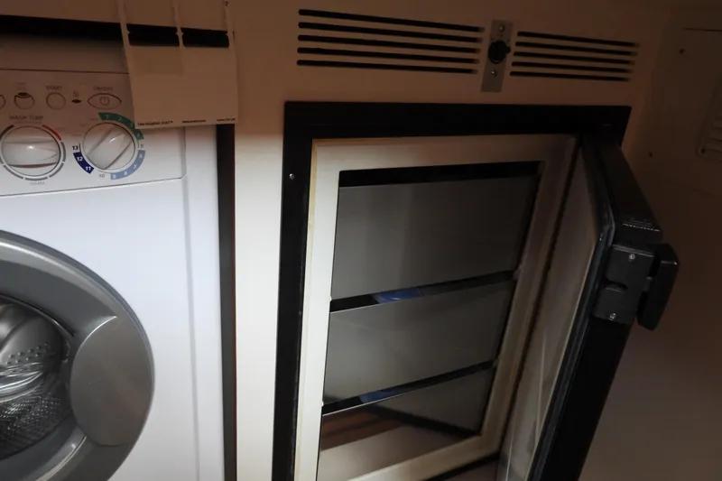  Yacht Photos Pics Laundry area with open fridge on 2015 Grand Banks 46 Eastbay SX yacht.