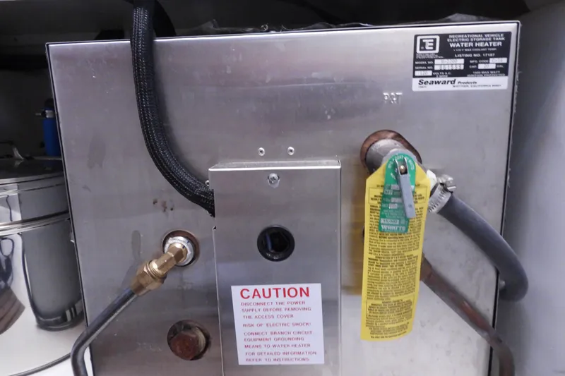 Yacht Photos Pics Water heater system on 2015 Grand Banks 46 Eastbay SX yacht, featuring caution labels and connections.