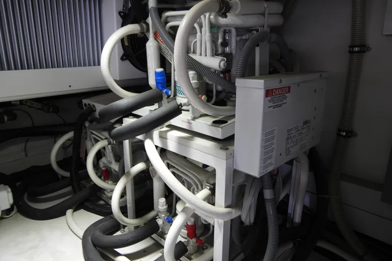  Yacht Photos Pics Engine room of 2015 Grand Banks 46 Eastbay SX with complex piping and machinery.