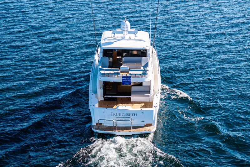True North Yacht Photos Pics 2020 Maritimo 59 Motoryacht cruising on open water, rear view.