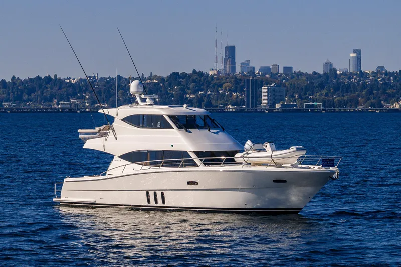 True North Yacht Photos Pics 2020 Maritimo 59 Motoryacht on water with city skyline in background.