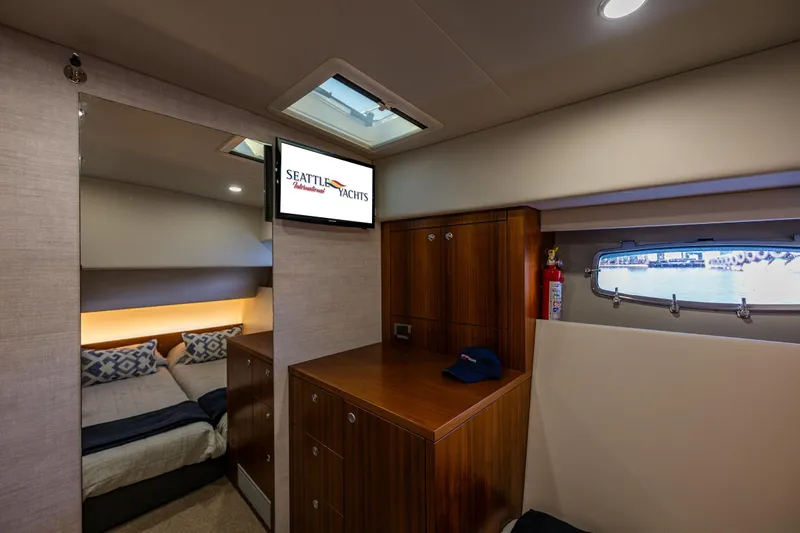 True North Yacht Photos Pics Luxurious interior of 2020 Maritimo 59 Motoryacht with cozy bedroom and elegant wood cabinetry.