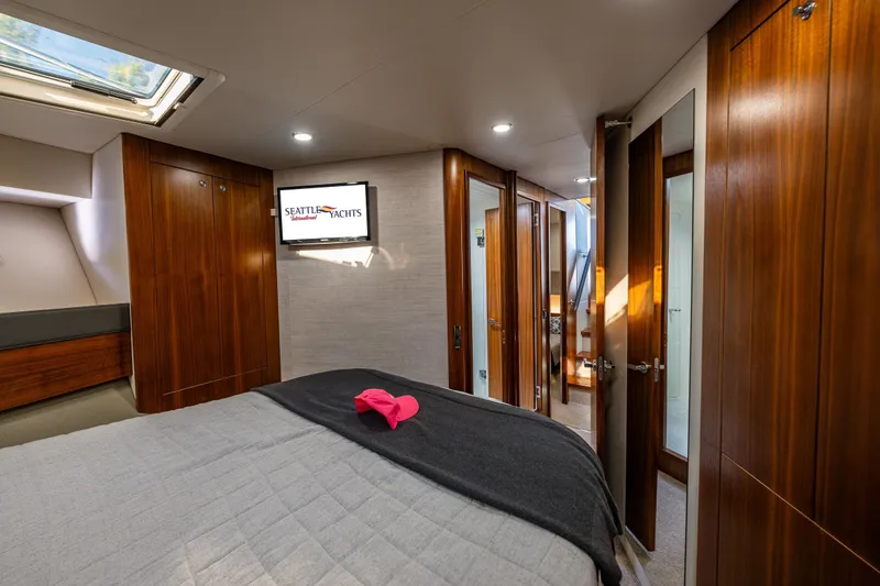 True North Yacht Photos Pics Luxurious interior of 2020 Maritimo 59 Motoryacht bedroom with wood finishes and skylight.