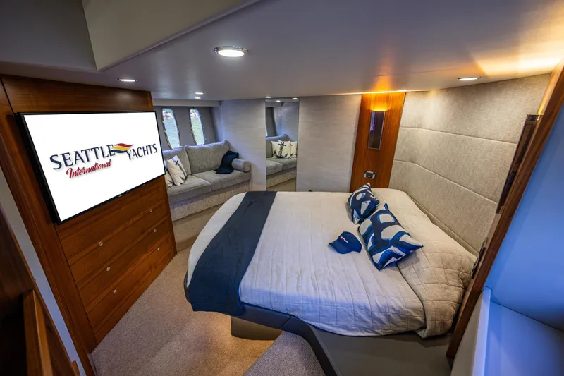 True North Yacht Photos Pics Luxurious bedroom interior of 2020 Maritimo 59 Motoryacht with modern decor and cozy seating.