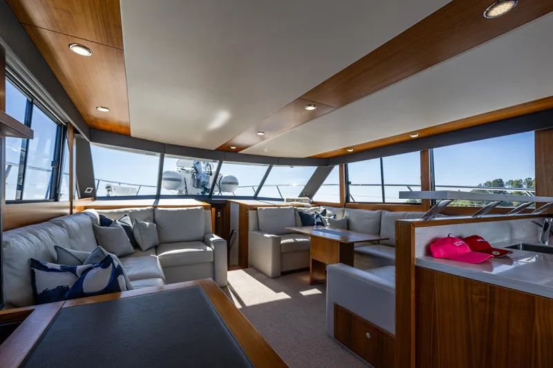 True North Yacht Photos Pics Luxurious interior of 2020 Maritimo 59 Motoryacht with elegant seating and panoramic windows.