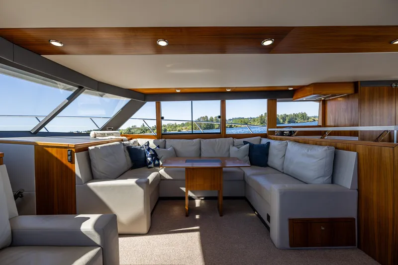 True North Yacht Photos Pics Luxurious interior of 2020 Maritimo 59 Motoryacht with plush seating and panoramic windows.